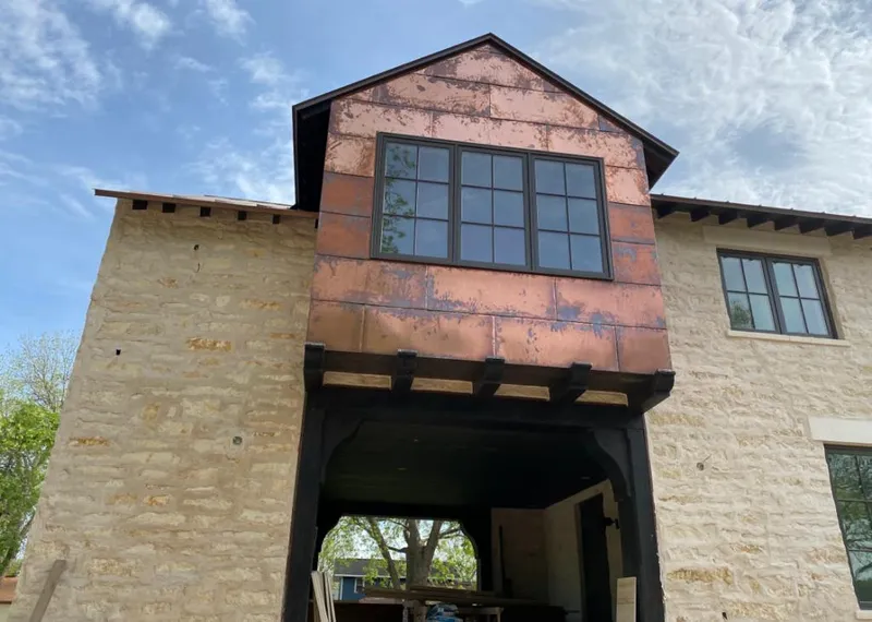 Copper metal panel facade on a stone building for Skylight Installation in Billerica